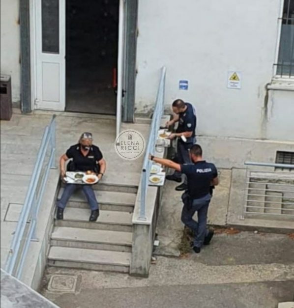 Poliziotti non vaccinati consumano il pasto sulle scale della mensa obbligatoria